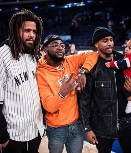 Davido pictured with US music artists, J-Cole and Trey Songs