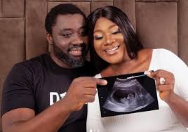 Mercy Johnson cradles her growing baby bump in new photos