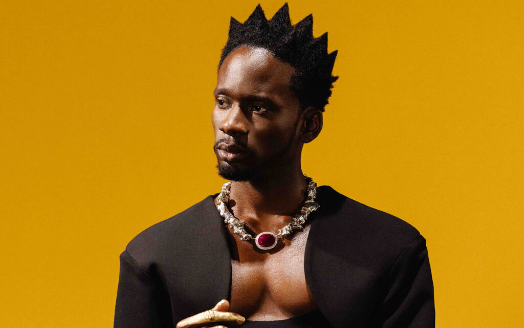 Mr. Eazi speaking at a music business event after reading Jay-Z's book