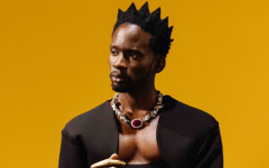 Mr. Eazi speaking at a music business event after reading Jay-Z's book