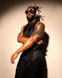 Flavour performing on stage in vibrant African attire, promoting his new song “Afro-Culture”