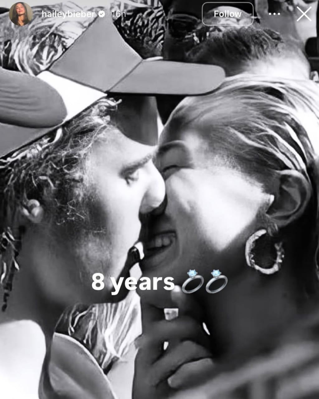 Hailey Bieber and Justin Bieber share a kiss in a black-and-white selfie posted to celebrate eight years since their engagement.