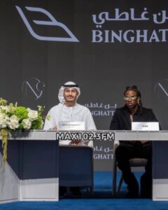 Rema signs documents after purchasing a luxury home at One by Binghatti in Dubai.