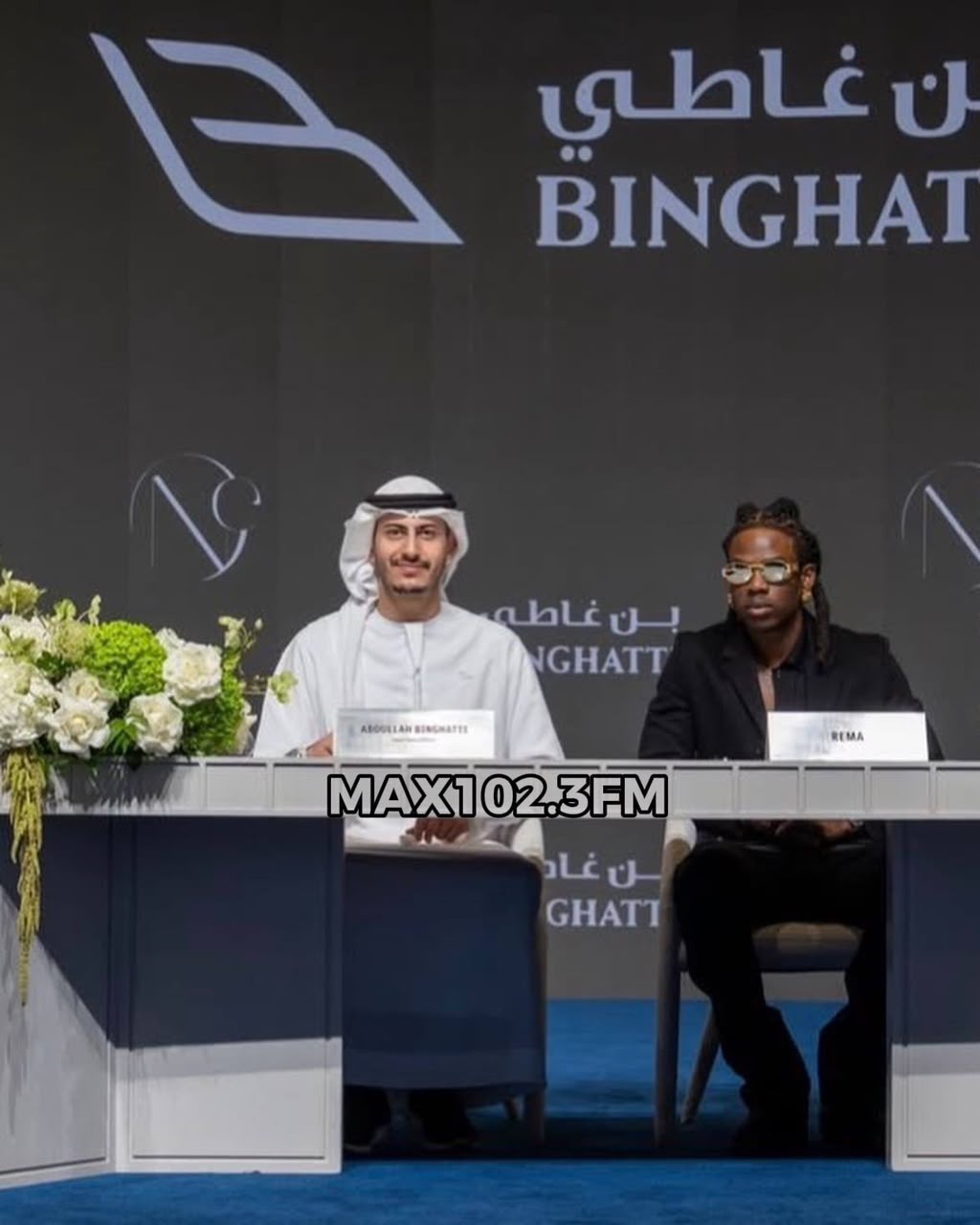 Rema signs documents after purchasing a luxury home at One by Binghatti in Dubai.